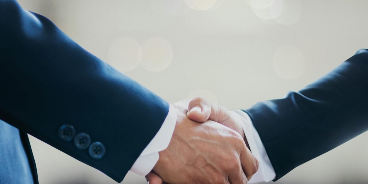 Two business professionals shaking hands, symbolizing trust, agreement, and the foundation of a new partnership.