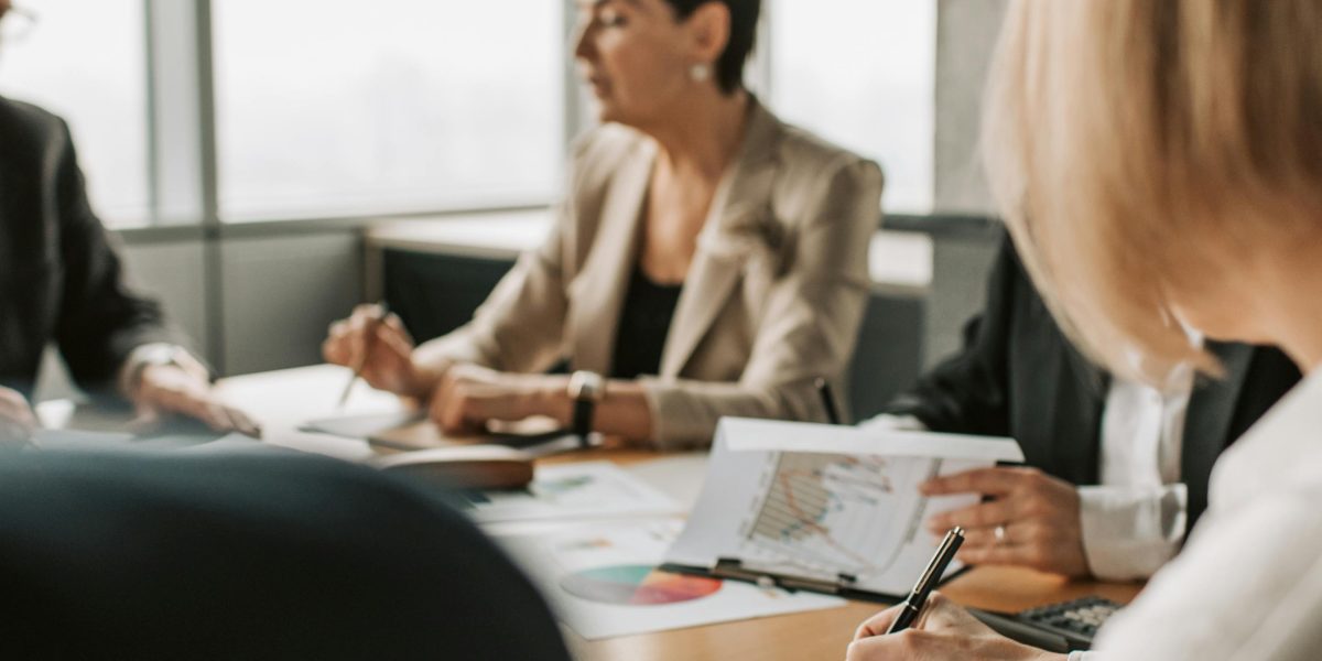 A team of professionals collaborating and strategizing during a complex negotiation, aiming for the best possible outcome.