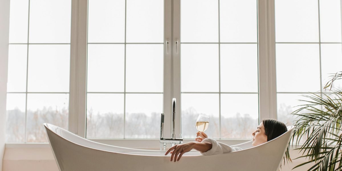 A person relaxing in a luxurious, tranquil setting, embodying the wellness-focused lifestyle offered by residences like Banyan Tree.