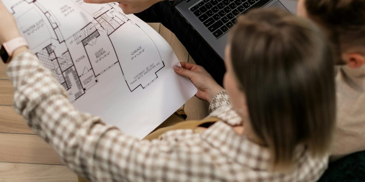 A couple earnestly discusses their plans for buying a home, representing the initial stages of property investment.