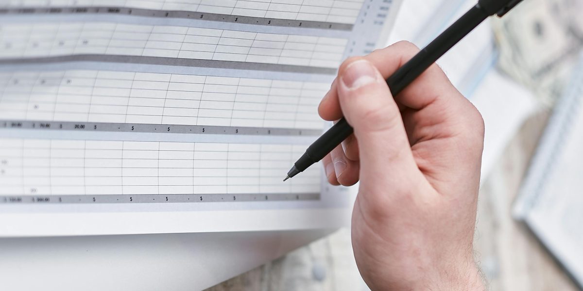 An individual reviewing financial documents and budgeting, representing the planning of property expenses.