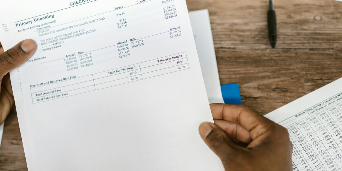 A person thoughtfully reviewing documents, symbolizing smart investment decisions.