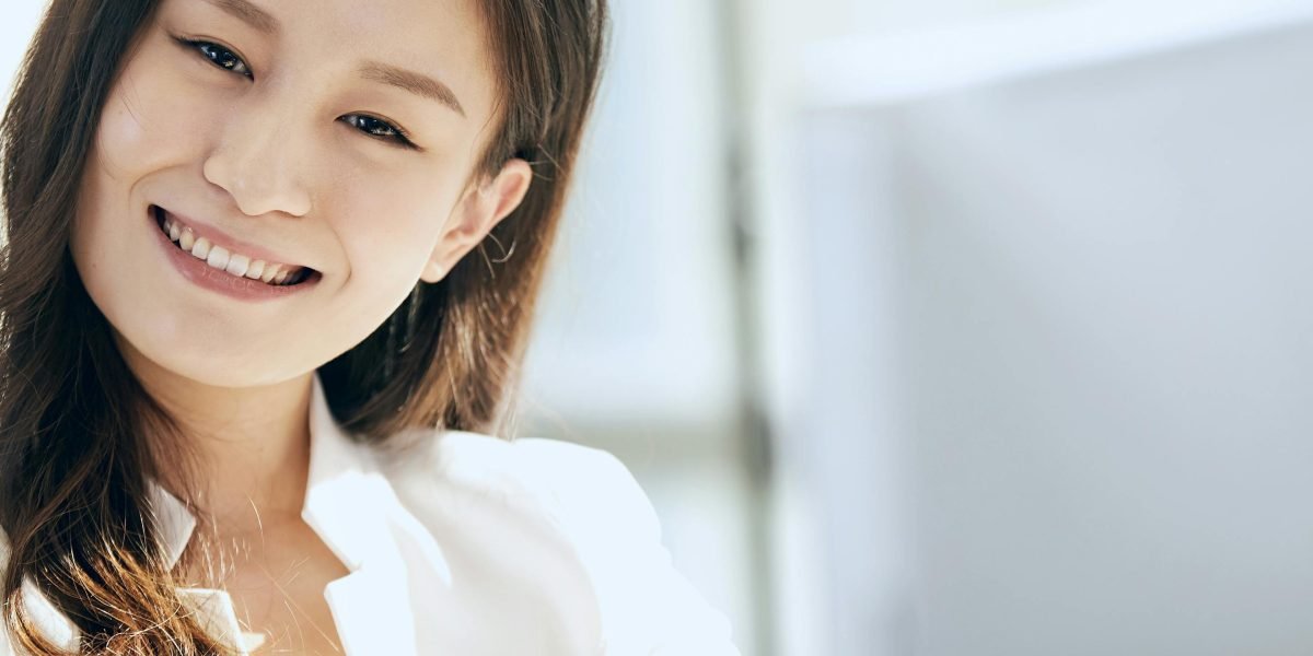 A person confidently smiling, looking towards a bright future after strategic planning.