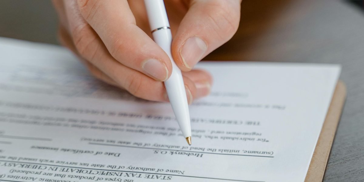 The crucial moment of signing a rental agreement, an essential step in Dubai's legal renting process.
