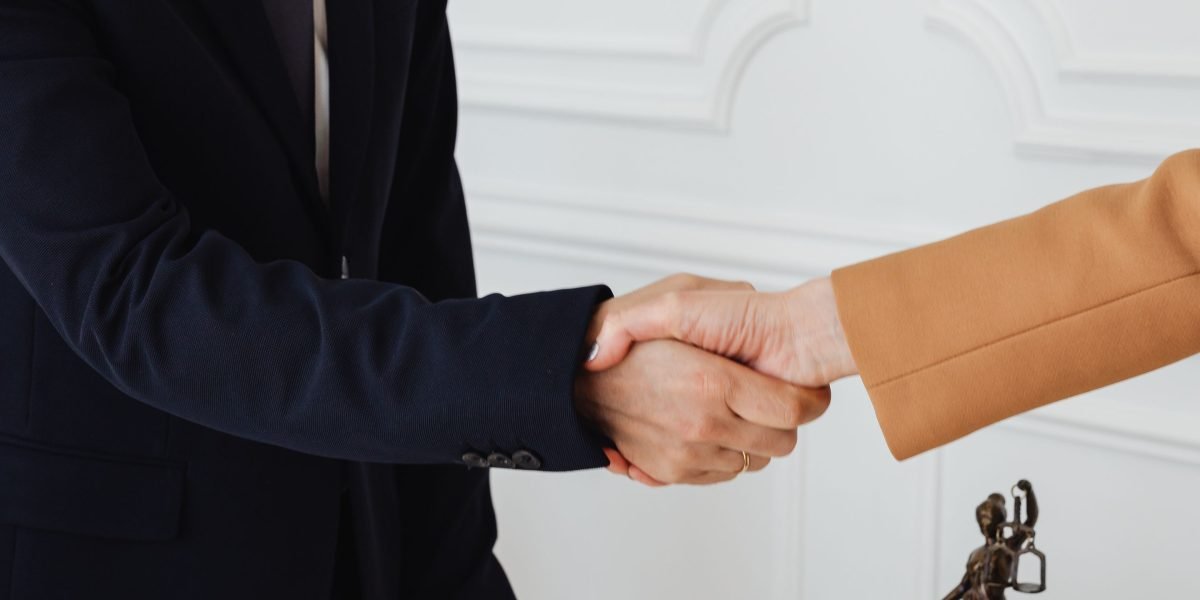 Two professionals shaking hands, symbolizing trust and a successful, transparent business agreement after negotiations.