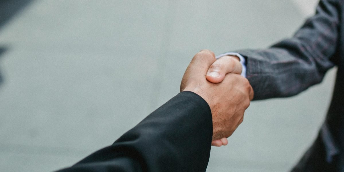 Professionals shaking hands, symbolizing trust and a successful partnership in real estate.