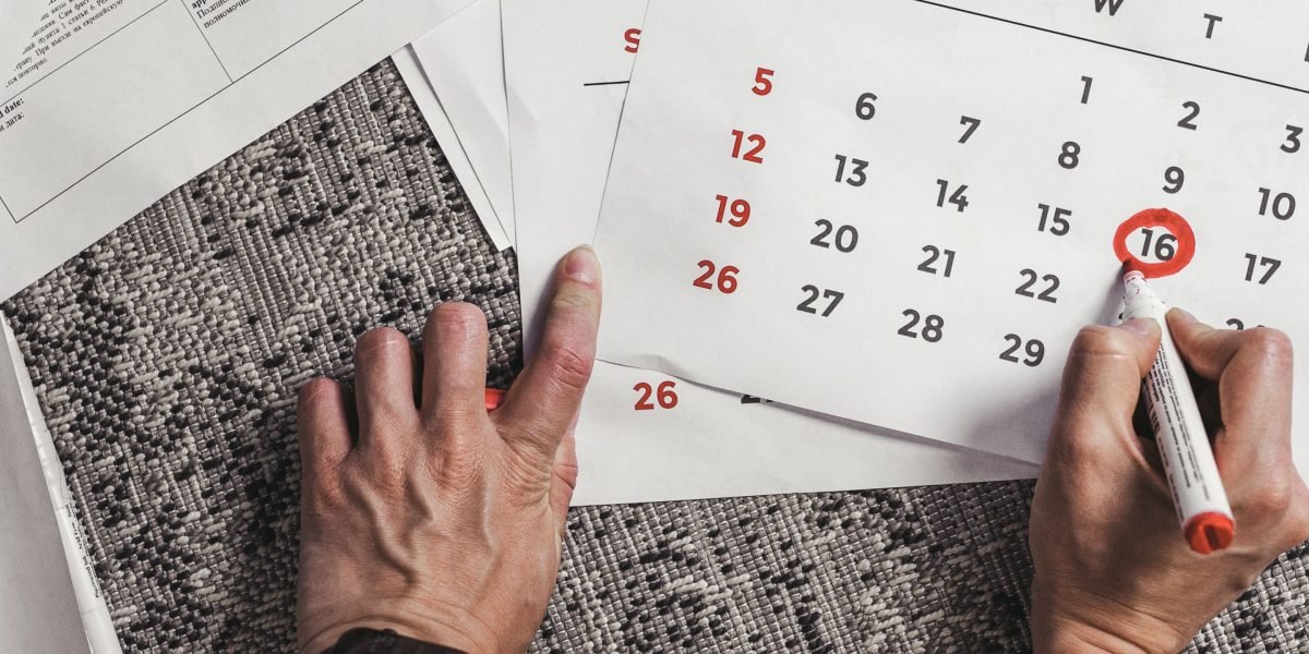 A thoughtful individual looking out a window, contemplating future plans and strategies.