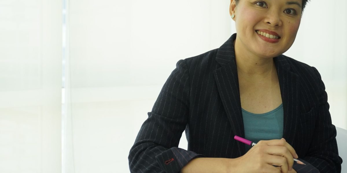 A person confidently reviews financial documents, reflecting the positive outcomes of property investment.