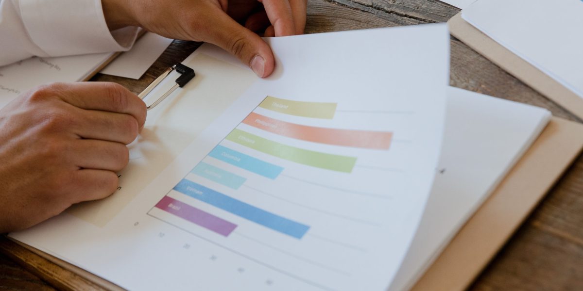 A person focused on financial documents, representing strategic planning for property investments and understanding tax implications.