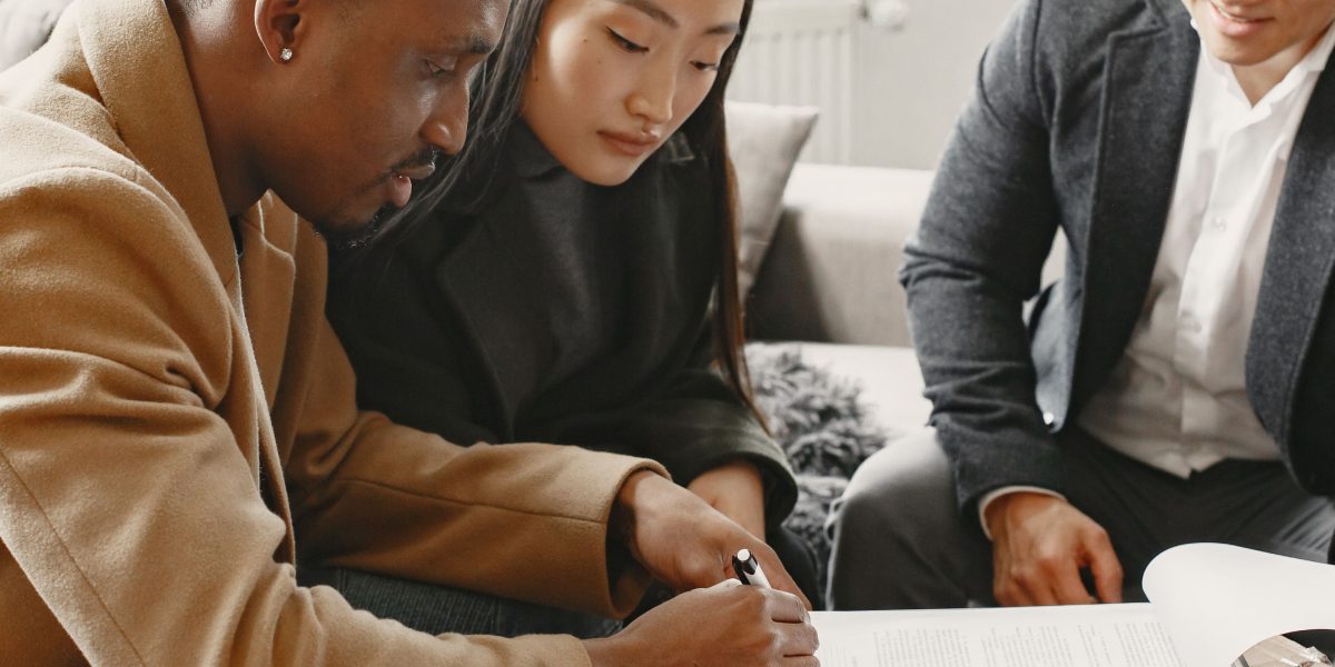 Individuals carefully review financial documents, symbolizing the initial steps to understanding property costs in Dubai.