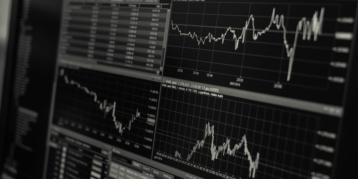 A person comparing global market data, emphasizing the importance of understanding local real estate nuances.