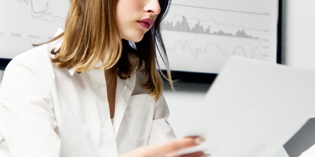 A professional meticulously reviewing documents, symbolizing the thorough evaluation of developer reputations and track records.