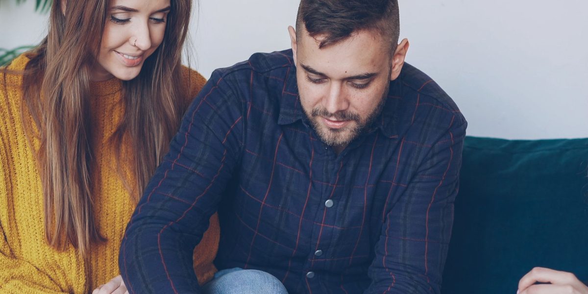 A couple reviewing investment documents with satisfaction, reflecting high rental yields.