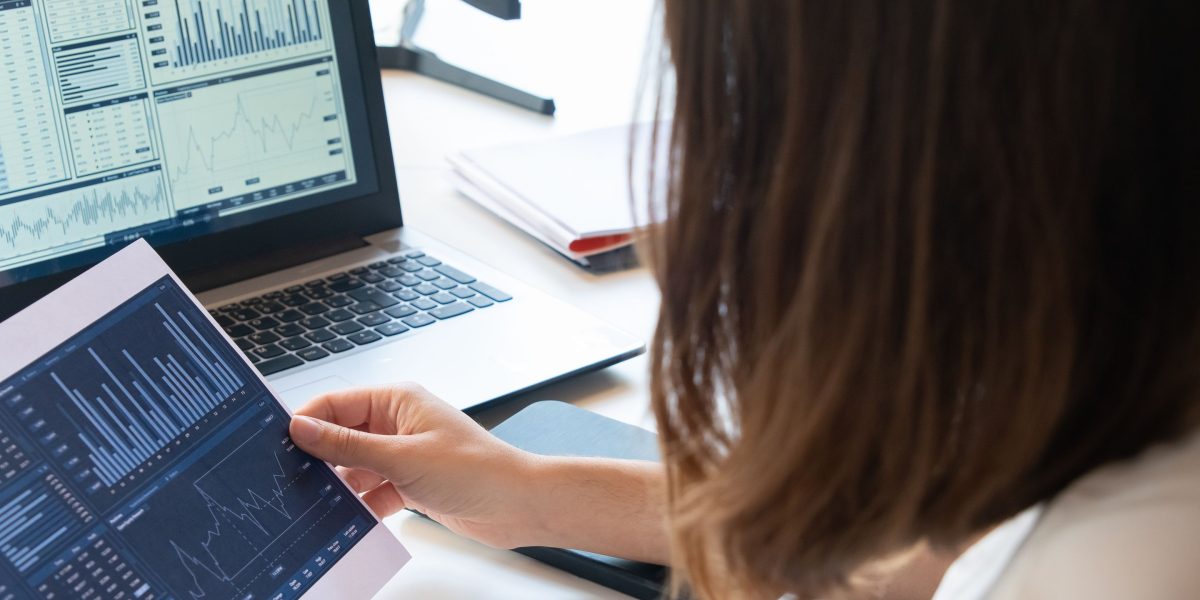 An investor thoughtfully reviewing various reports and data on Dubai's property market to make informed decisions.