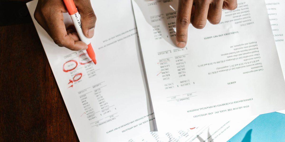 An individual meticulously reviewing legal documents, emphasizing the importance of due diligence in property investment.
