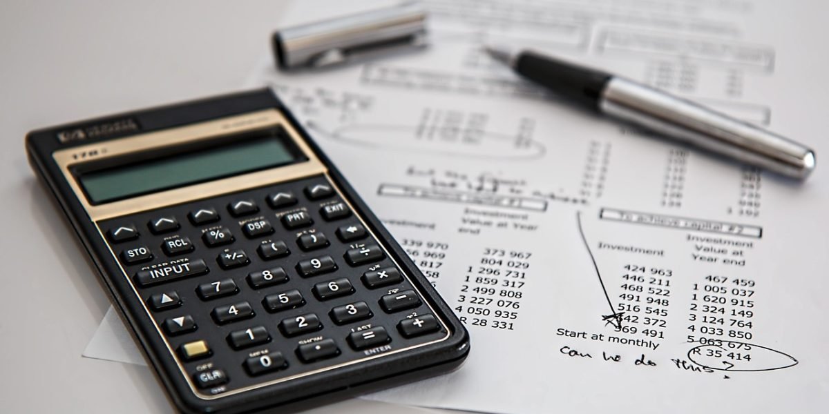 A person confidently reviewing financial documents, reflecting the positive financial outcomes of property investment.