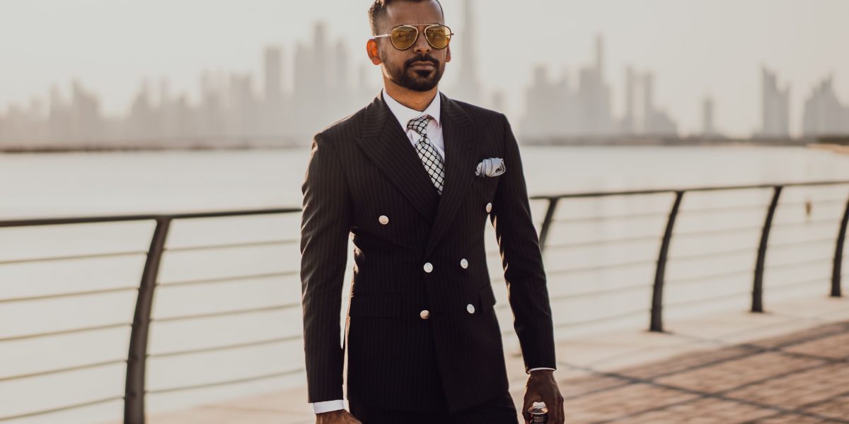 An expat standing confidently, gazing at the impressive Dubai skyline, symbolizing aspirations of property ownership and residency.